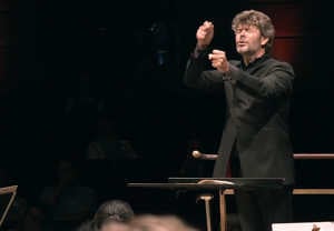 Man conducting with intense. From the concert.