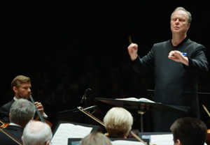 Man smiling at the orchestra. from the concert.