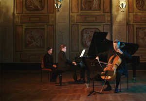 One man plays the cello and one man is playing the piano. From the concert.