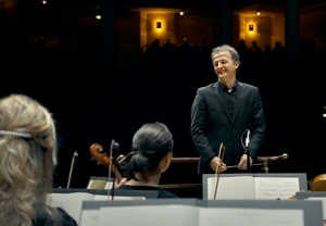 Man smiling on stage. Photo.